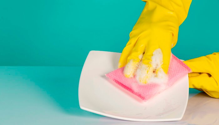 dishwasher-wearing-yellow-gloves-on-blue